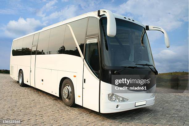 a luxurious white coach with tinted windows - coach bus stock pictures, royalty-free photos & images