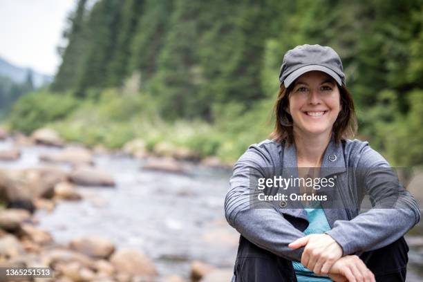 portrait of women relaxing by the river in quebec - trout fishing stock pictures, royalty-free photos & images