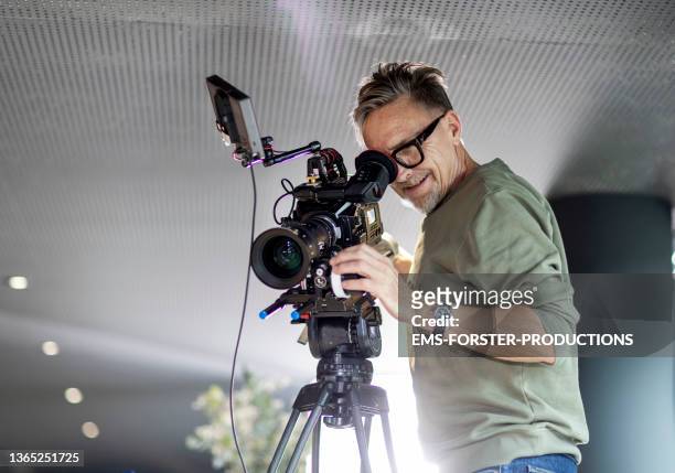 close up of cameraman filming in restaurant - filming fotografías e imágenes de stock
