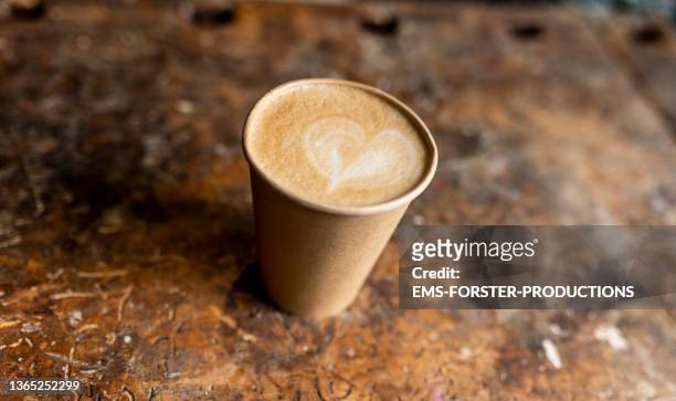 disposable paper coffee cup on a wooden table - disposable stock pictures, royalty-free photos & images