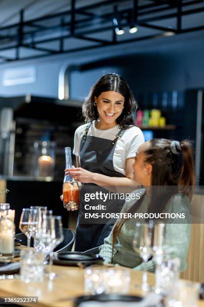 young and beautiful waitress is serving a white wine - waitress bildbanksfoton och bilder