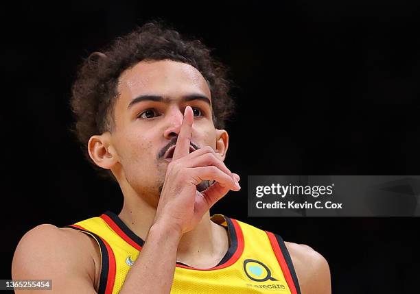 Trae Young of the Atlanta Hawks reacts after hitting a three-point basket against the Milwaukee Bucks during the first half at State Farm Arena on...