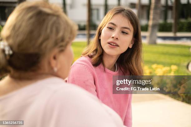 grandmother and granddaughter talking outdoors - chubby granny stock pictures, royalty-free photos & images