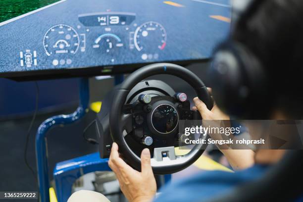 gaming game play tv fun gamer gamepad guy controller video console playing player holding hobby playful enjoyment view concept - car racing video game stock pictures, royalty-free photos & images