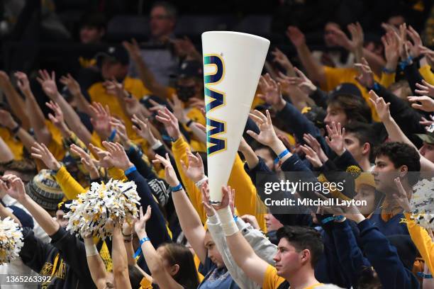 The West Virginia Mountaineers fans cheer during a college basketball game against the Oklahoma State Cowboys at the WVU Coliseum on January 11, 2022...