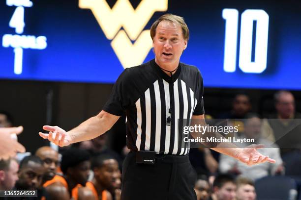 Referee John Higgins looks on during a college basketball game between the West Virginia Mountaineers and the Oklahoma State Cowboys at the WVU...