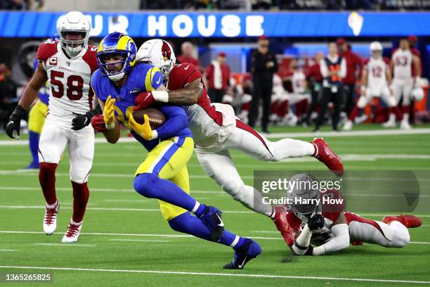 Tyler Higbee of the Los Angeles Rams runs with the ball while being tackled by Isaiah Simmons of the Arizona Cardinals in the first quarter of the...