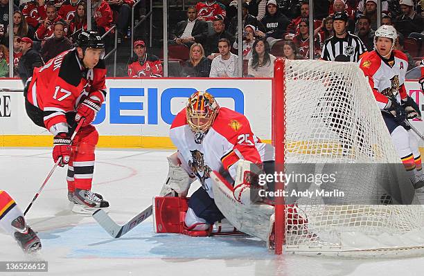 Ilya Kovalchuk of the New Jersey Devils puts the puck into the back of the net past Jacob Markstrom of the Florida Panthers for the game-winning goal...