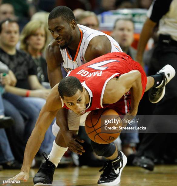 Kemba Walker of the Charlotte Bobcats battles for a ball with Jannero Pargo of the Atlanta Hawks during their game at Time Warner Cable Arena on...