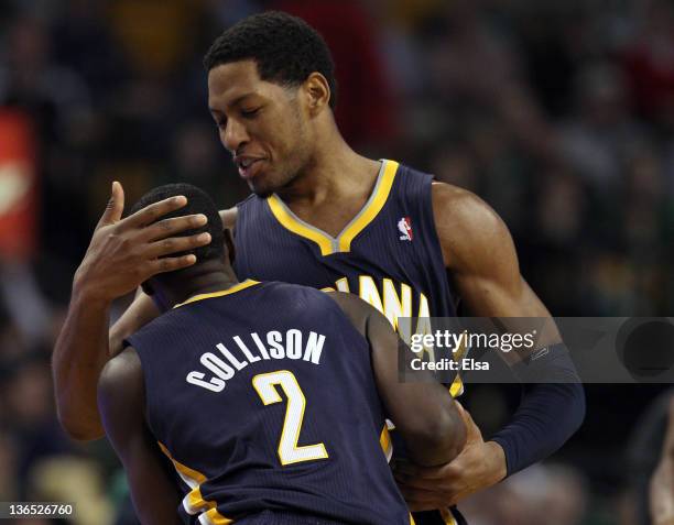 Danny Granger of the Indiana Pacers congratulates Darren Collison after Collison shot a 3-point shot late in the fourth quarter against the Boston...