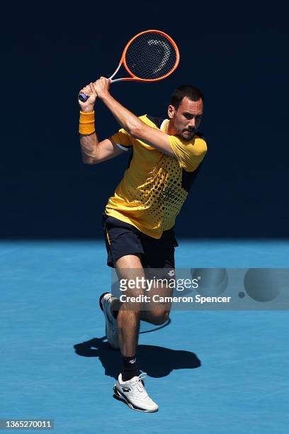 Gianluca Mager of Italy plays a backhand in his first round singles match against Andrey Rublev of Russia during day two of the 2022 Australian Open...