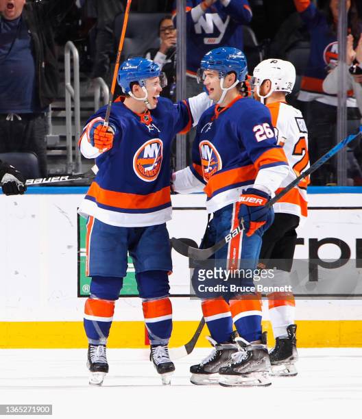 Anthony Beauvillier of the New York Islanders celebrates his third period goal against the Philadelphia Flyers and is joined by Oliver Wahlstrom at...