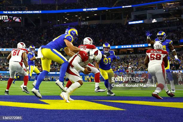 Kyler Murray of the Arizona Cardinals is tackled by by Leonard Floyd of the Los Angeles Rams in the second quarter of the NFC Wild Card Playoff game...