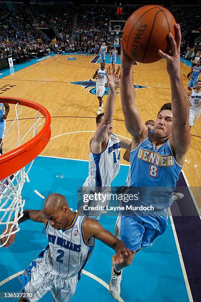 Danilo Gallinari of the Denver Nuggets goes to the basket against double block during an NBA game between the Denver Nuggets and the New Orleans...