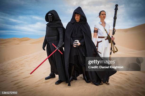 Star Wars cosplayers Shane Holly as Kylo Ren, Austin Verberg as Luke Skywalker, and Leah Panos as Rey Skywalker pose for photos at Buttercup Sand...