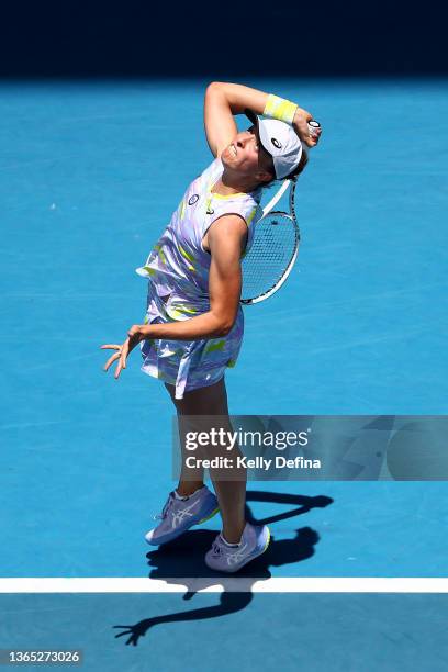 Iga Swiatek of Poland plays serves in her first round singles match against Harriet Dart of Great Britain during day two of the 2022 Australian Open...