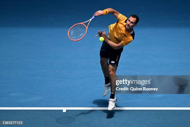 Gianluca Mager of Italy serves in his first round singles match against Andrey Rublev of Russia during day two of the 2022 Australian Open at...