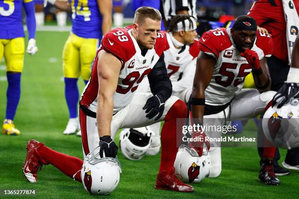 Watt and Chandler Jones of the Arizona Cardinals take a knee during an injury timeout in the third quarter against the Los Angeles Rams in the NFC...