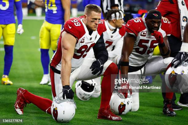Watt and Chandler Jones of the Arizona Cardinals take a knee during an injury timeout in the third quarter against the Los Angeles Rams in the NFC...