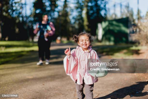 family walking in a park together - january 3 stock pictures, royalty-free photos & images