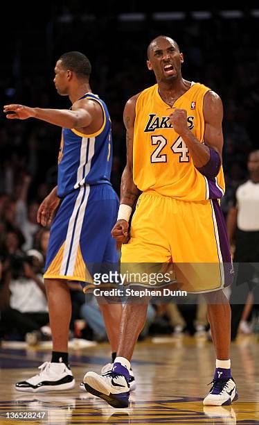 Kobe Bryant of the Los Angeles Lakers celebrates after making a three point basket at the buzzer ending the third period against the Golden State...