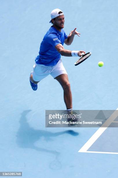 Joao Sousa of Portugal plays a forehand in his first round singles match against Jannik Sinner of Italy during day two of the 2022 Australian Open at...