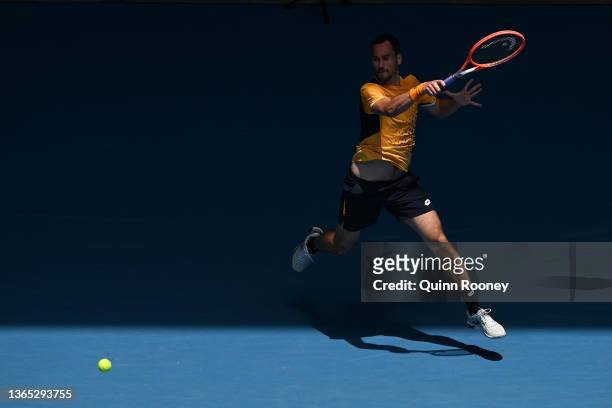 Gianluca Mager of Italy plays a forehand in his first round singles match against Andrey Rublev of Russia during day two of the 2022 Australian Open...