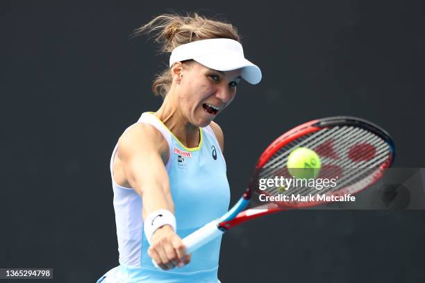 Viktorija Golubic of Switzerland plays a backhand in her first round singles match against Shuai Zhang of China during day two of the 2022 Australian...