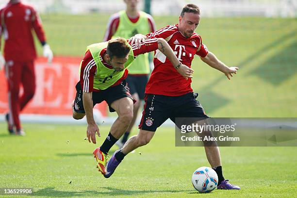 Franck Ribery is challenged by Diego Contento during a training session of Bayern Muenchen at the ASPIRE Academy for Sports Excellence on January 7,...