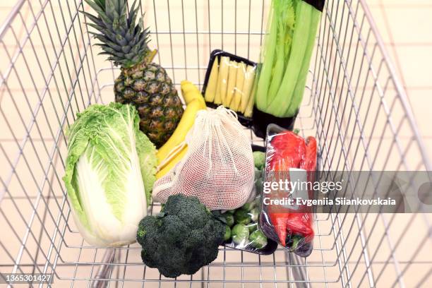 shopping trolley with products in supermarket. - full shopping cart stock pictures, royalty-free photos & images
