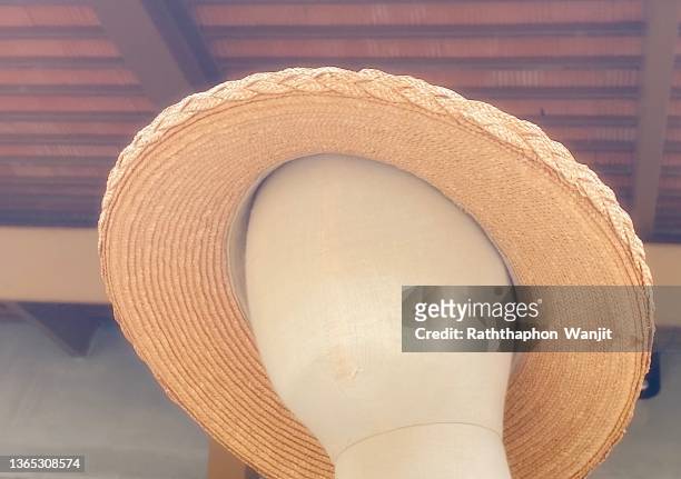 a wicker hat made from dried bamboo on a mannequin. - white hat fashion item stockfoto's en -beelden