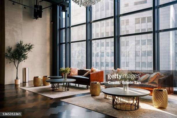 lounge with sofa , carpet and coffee table against window with city view lobby area - lobby bildbanksfoton och bilder