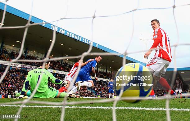 Danny Kedwell of Gillingham scores the opening goal past Asmir Begovic of Stoke City as teammate Robert Huth looks on during the FA Cup Third Round...