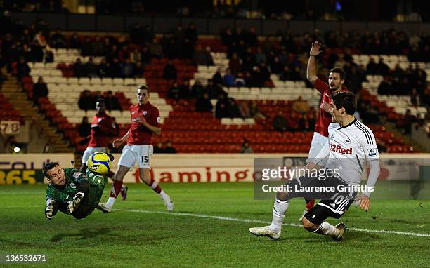 Danny Graham of Swansea scores the third past a diving Luke Steele of Barnsley during the FA Cup Third Round match sponsored by Budweiser between...