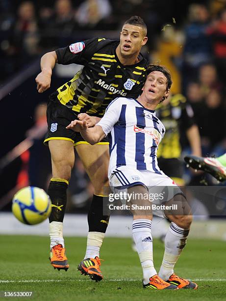 Rudi Gestede of Cardiff City is challenged by Billy Jones of West Bromwich Albion during the FA Cup Third Round match between West Bromwich Albion...