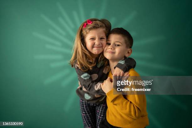 siblings love - family on coloured background stock pictures, royalty-free photos & images