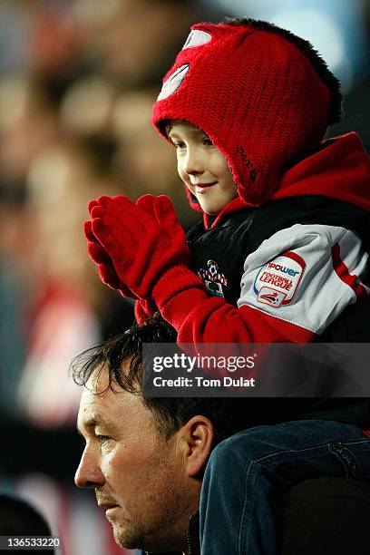 Young Southampton fan applauds during the FA Cup 3rd round match between Coventry City and Southampton at the Ricoh Arena on January 07, 2012 in...