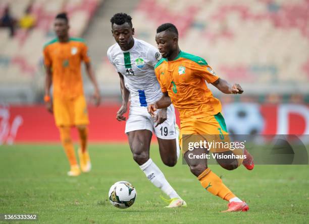 Of Sierra Leone chases GHISLAIN KONAN of Ivory Coast during the Group E Africa Cup of Nations 2021 match between Ivory Coast and Sierra Leone at...