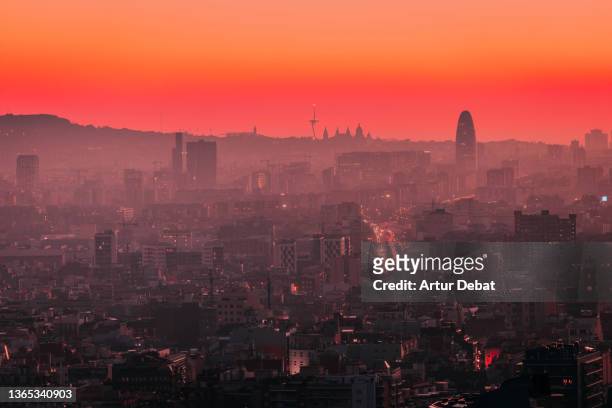 the skyline of barcelona seen from distance with dusk sky and architecture. - hauptverkehrszeit stock-fotos und bilder