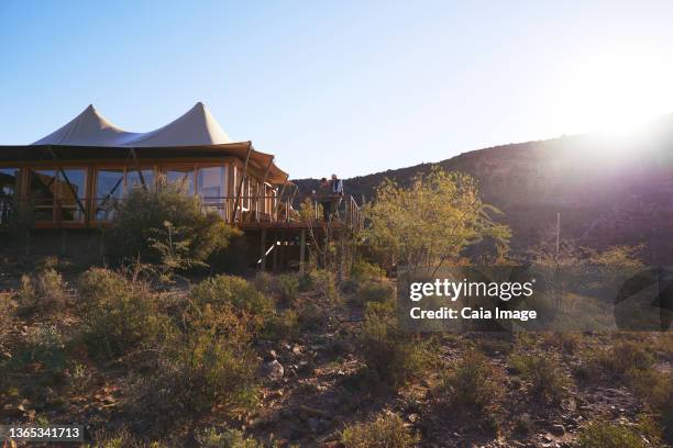 senior couple on sunny safari lodge hotel balcony - safari lodge stock pictures, royalty-free photos & images