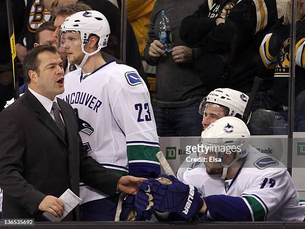 Head coach Alain Vigneault of the Vancouver Canucks reacts to a penalty against one of his players during the game against the Boston Bruins on...