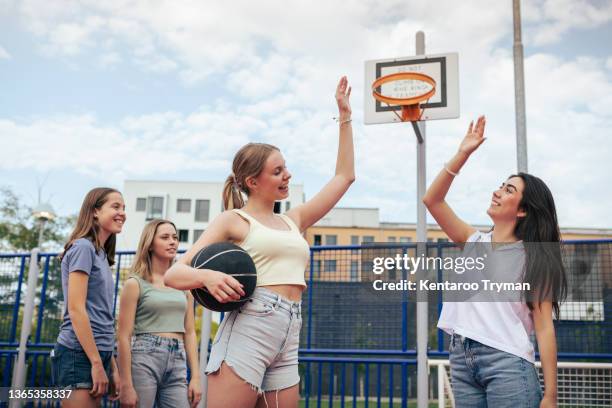 two girls does high five during a basketball game - women's basketball bildbanksfoton och bilder