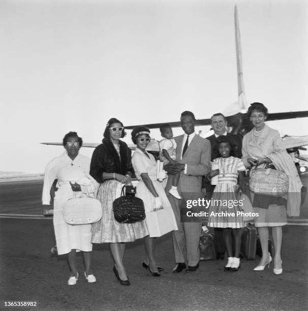 American singer, actor and jazz pianist Nat King Cole arrives at Nice Airport in France with his family, 5th August 1960. Accompanying him are his...