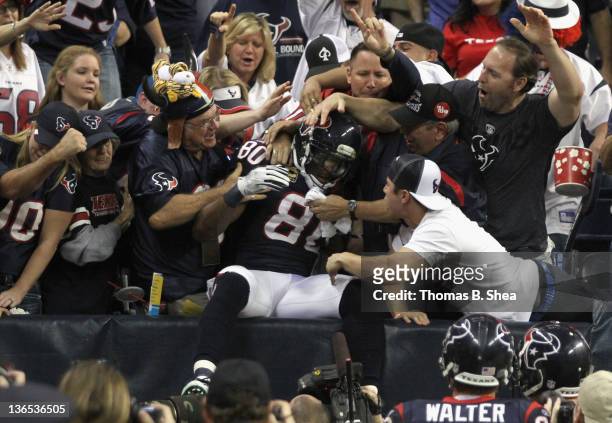 Andre Johnson of the Houston Texans celebrates with fans after he scored a 40-yard touchdown reception in the third quarter against the Cincinnati...