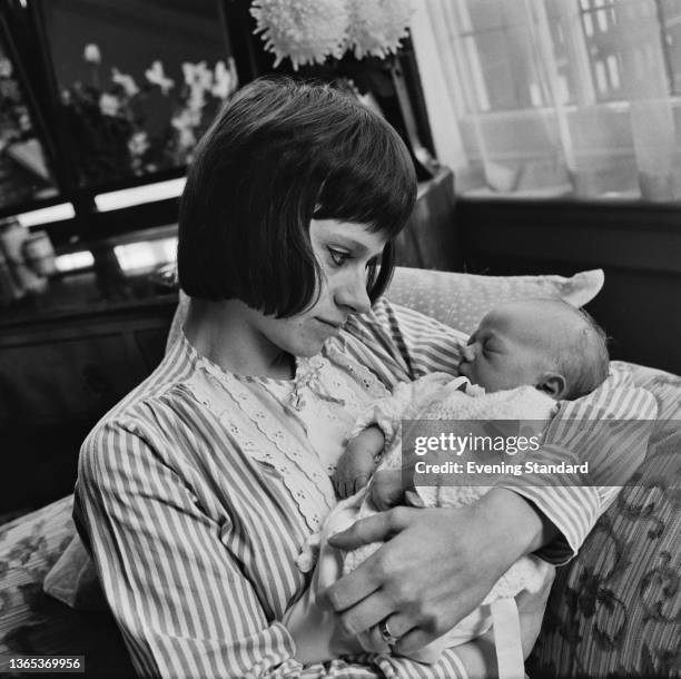 English actress Rita Tushingham with her baby daughter Dodonna, UK, 4th May 1964.