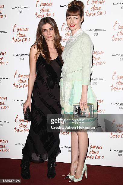 Louise Bourgoin and Elisa Sednaoui attend 'L'Amour Dure Trois Ans' Premiere at Le Grand Rex on January 7, 2012 in Paris, France.