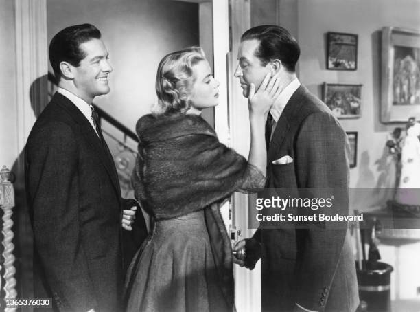 American actor Robert Cummings, american actress Grace Kelly and british actor Ray Milland on the set of the movie Dial M for Murder directed and...