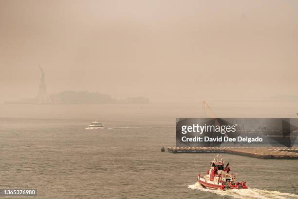Smoke from wildfires in Canada shrouds the Statue of Liberty on June 30, 2023 in New York City. The eastern U.S. Is once again experiencing air...