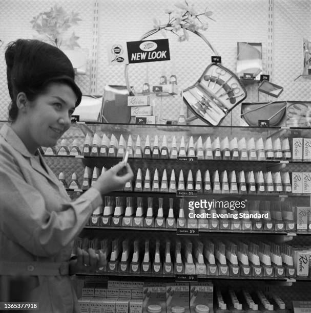 Shop assistant suggests a shade of nail varnish at Boots the Chemist on Regent Street in London, UK, 11th May 1964.