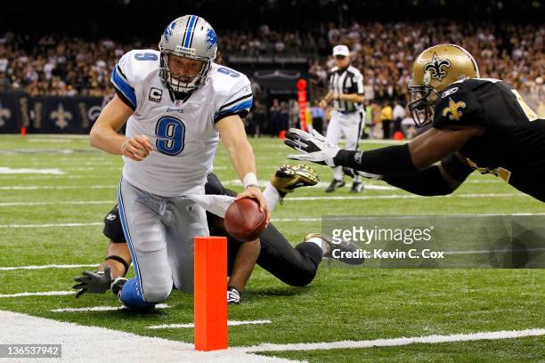Matthew Stafford of the Detroit Lions dives for the touchdown against Roman Harper and Will Smith of the New Orleans Saints during their 2012 NFC...